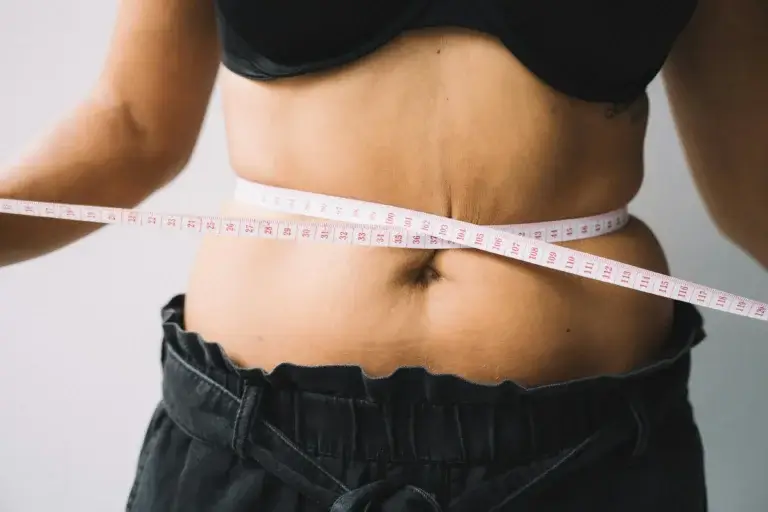 photo of woman with measuring tape around waist