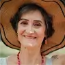 woman with hat smiling at camera