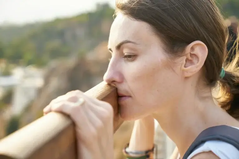 photo of woman looking over railing