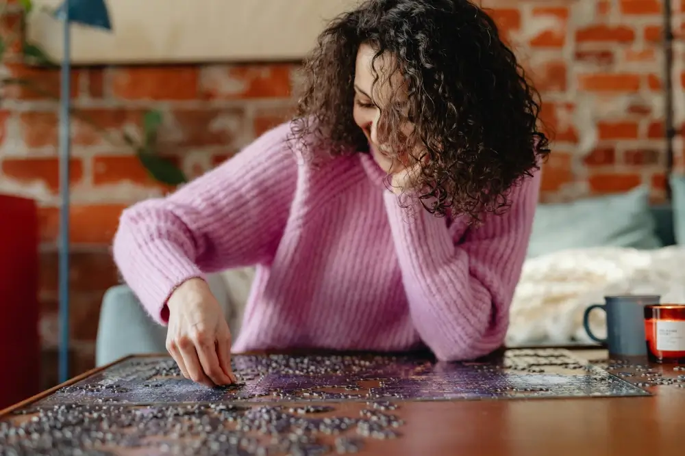 woman putting a puzzle togetther